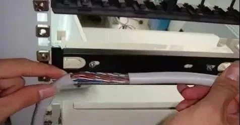 Route the cables along both sides of the cabinet to the patch panel, leaving approximately 25 centimeters of the large-pair cable. Use a cable stripper or wire stripper to remove the outer sheath of the large-pair cable Route the cables along both sides of the cabinet to the patch panel, leaving approximately 25 centimeters of the large-pair cable. Use a cable stripper or wire stripper to remove the outer sheath of the large-pair cable